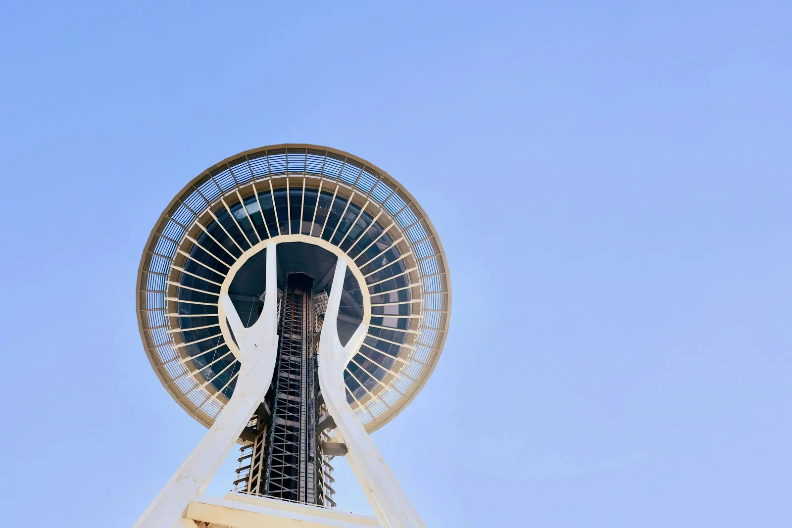The Seattle Space Needle seen from below against a clear blue sky